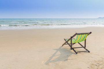 Fototapeta na wymiar Beach chair on the sand ( feel lonely concept)