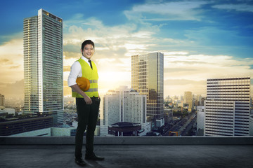 Fototapeta na wymiar Asian engineer wearing safety vest