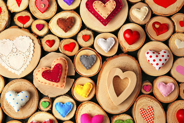 Valentine's Day concept. Different handmade hearts on wooden stumps background