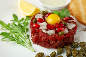 Beef tartare served on a white plate, close up