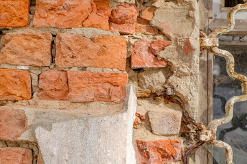 Old brick wall plaster rusty iron grill background window