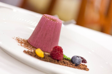 Berry ice cream with cocoa powder and fresh fruits.