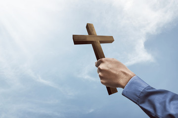 Fototapeta premium Human hand holding christian cross