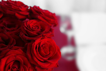 Red roses on a holiday served table, closeup