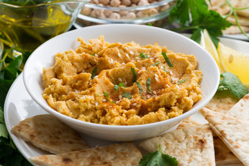 bowl of Arabic sauce hummus with flatbread