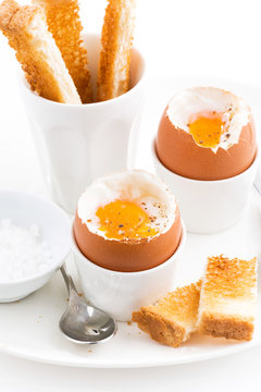 boiled eggs and crispy toast for breakfast, closeup vertical