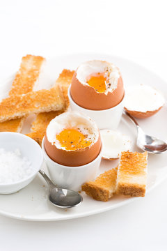 boiled eggs and crispy toast for breakfast, vertical