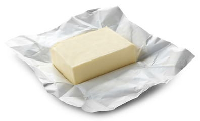 Piece of butter on paper, closeup