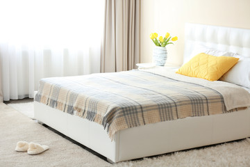 Bedroom interior in light tones with white furniture