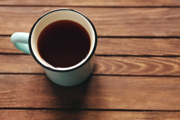 Mug of tea on wooden background