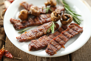 Grilled beef with vegetables on plate