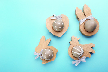 Easter eggs on wooden stands, top view