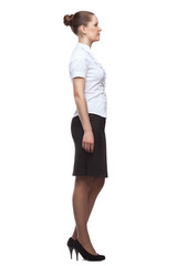 Fototapeta premium Profile of young woman in full growth on white background