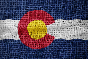 Colorado flag on sackcloth textured background