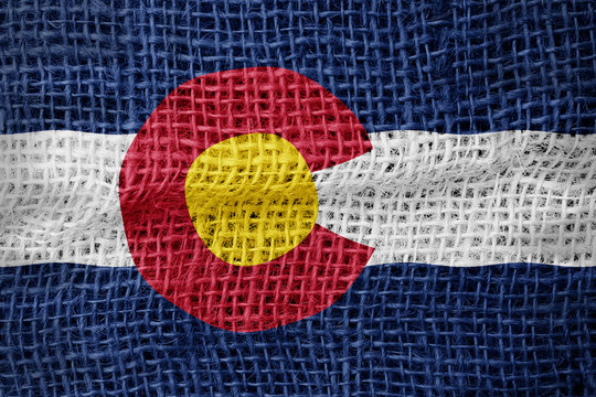 Colorado flag on sackcloth textured background