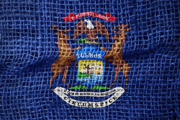 Michigan flag on sackcloth textured background