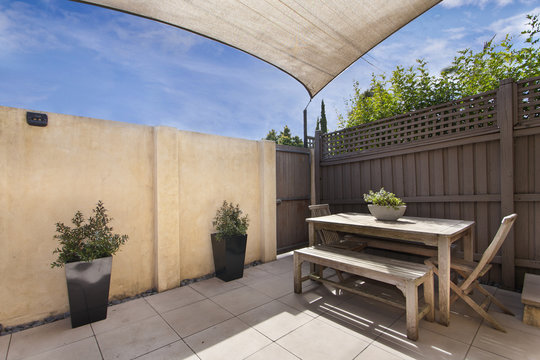 Backyard cozy patio area with wicker furniture set
