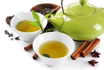 Green tea with utensils and spices, isolated on white