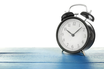 Alarm clock on blue table.