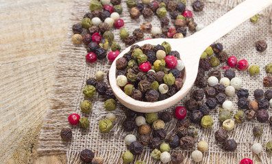 Color pepper on a wooden background.