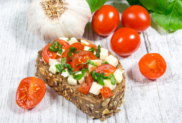 Ciabatta bread with tomatoes, mozzarella and basil.