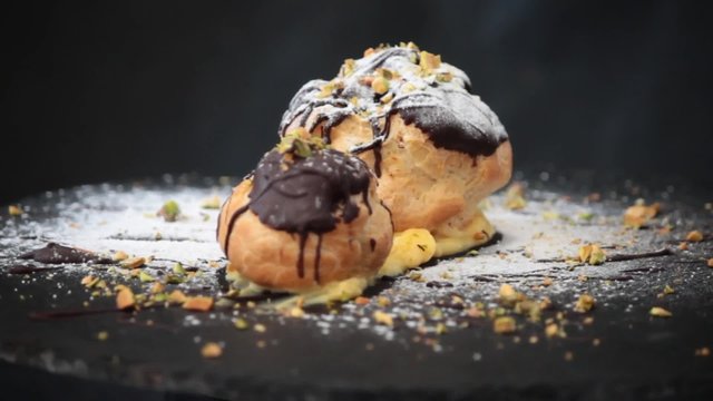 Profiteroles with cream,chiocolate and pistachios