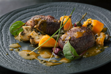 Delicious beef medallions with papaya  sauce on a plate