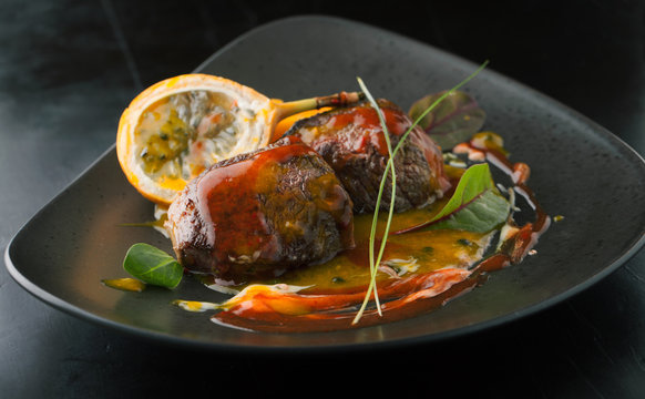 Delicious beef medallions with papaya and Granadilla sauce on a