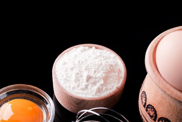 flour and ingredients on a black background
