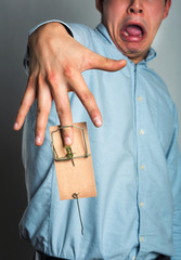 Businessman's hand in the mousetrap