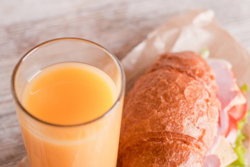 orange juice and a croissant sandwich