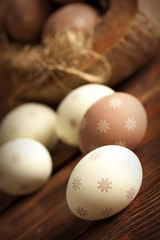 Brown and white Easter eggs on wooden table