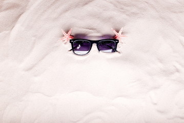 face buried in the sand on the beach