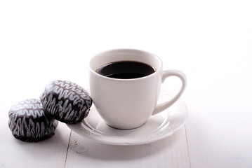 classic white cup of coffee with chocolate cookies