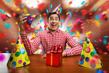 Man playing with Birthday hats