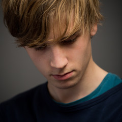 Confident Teenage Blond Young Man In The Studio