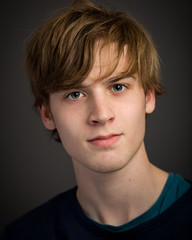 Confident Teenage Blond Young Man In The Studio