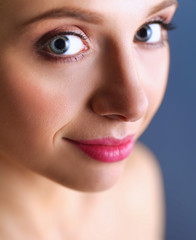 Fototapeta premium A beautiful woman, portrait isolated on blue background