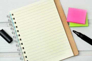 Notebook with marker and note