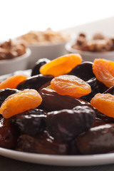 Mix of dried fruits and nuts on a wooden table