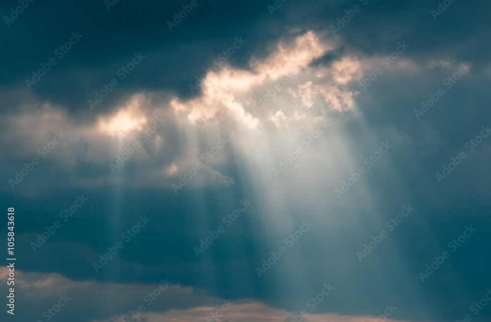 Wall mural Rays of the sun breaking through the clouds
