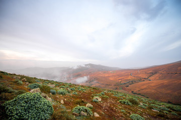 Fototapeta na wymiar Mountain landscape at the central part of Fuerteventura island on the cloudy and foggy weather in Spain