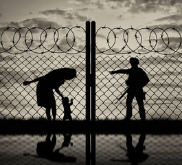 Silhouette refugee mother with a baby