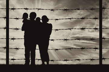 Silhouette of a family with children of refugees