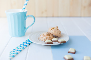 cookies with chocolate and blue mug of milk