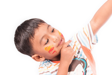 little boy play painting on face