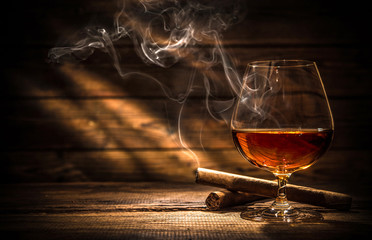 Whiskey with smoking cigar