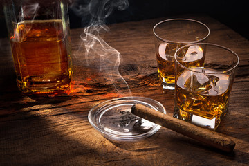 Whiskey with smoking cigar