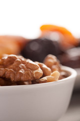 Cleaned walnuts in a white bowl closeup