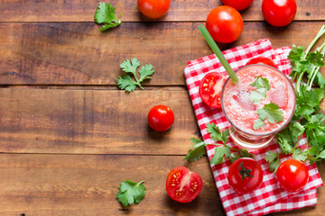 Tomato smoothie on wooden background